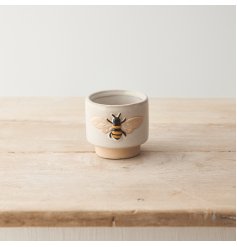 A chic, country living style stoneware planter with an embossed bee design. 