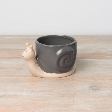 A cute plant pot in a snail design featuring a grey and neutral colour tone. 