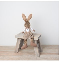 A charming bunny decoration dressed in dungarees with polka dots and a bow tie. 