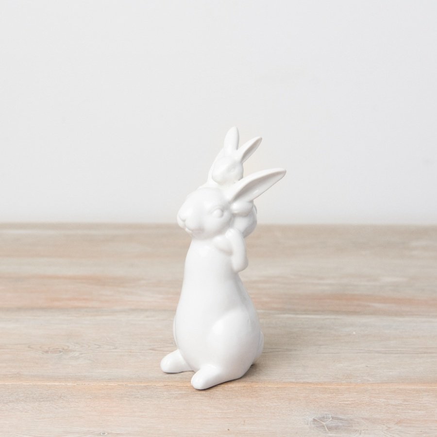 A chic and contemporary porcelain ornament featuring a large and small bunny figure. 