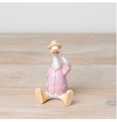 A unique sitting duck figure in a pretty pastel coloured jacket, hat and boots