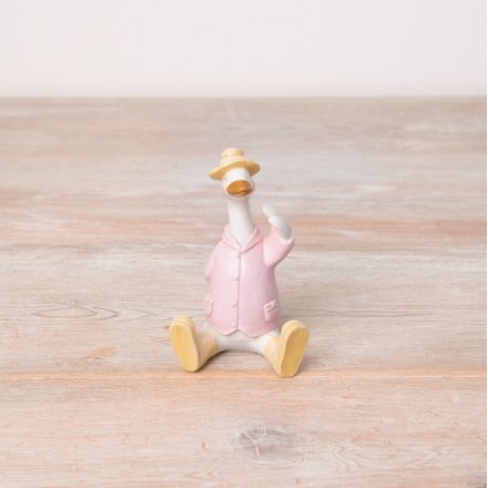 A unique sitting duck figure in a pretty pastel coloured jacket, hat and boots