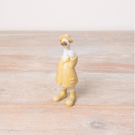 A chic standing duck ornament in fresh pastel yellow colours. An adorable item with yellow boots, hat and jacket.