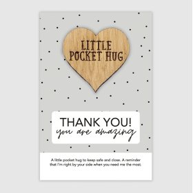A heart shaped token to say Thank you attached to a dotty printed backing card.