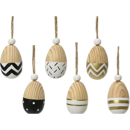 6 assorted wooden egg decorations with gold, black and white detailing. 