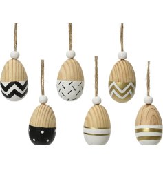 6 assorted wooden egg decorations with gold, black and white detailing. 