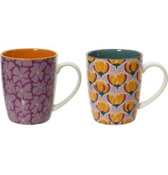 An assortment of 2 floral mugs. Each has a bold and beautiful print in stylish purple, orange and green colours. 
