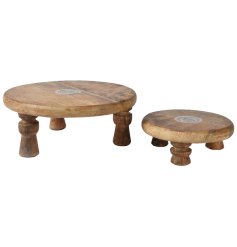 Add a touch of style to your kitchen or dining room with these distinctive elevated mango wood plates.