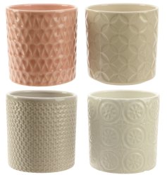 4 assorted planters each with a textured design. 