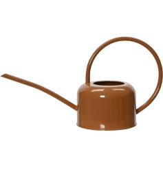 A chic watering can in brown, with a oversized handle and spout. 