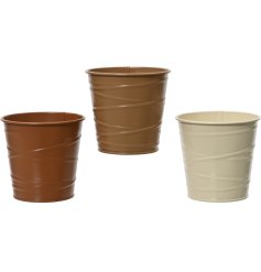 An assortment of 3 small boho style planters in cream and brown colours, each with a swirl detail effect.