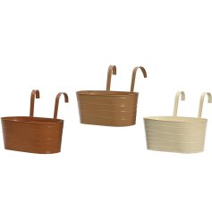 An assortment of 3 boho style planters in cream and brown tones with a swirl effect detail. 