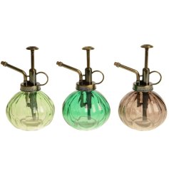 An assortment of 3 water spray bottles in different shades of green.