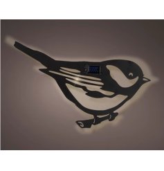 A black solar powered bird decoration for the outdoors.