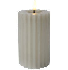 A real wax candle with a LED wick. Detailing a carved design with a melted pit.