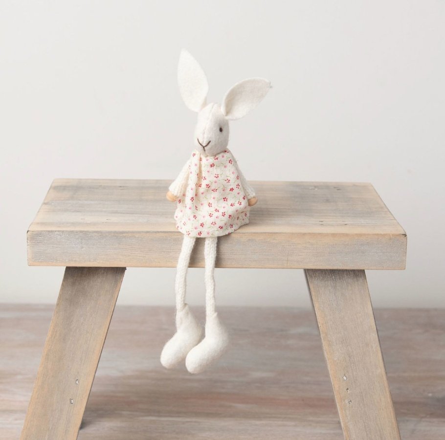 A charming white rabbit decoration which has been crafted from felt and fabric with knitted elements. 