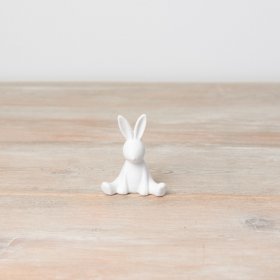 An adorable sitting bunny ornament. Contemporary in design with a subtle textured surface.