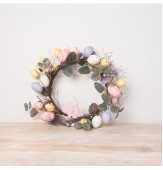A beautifully detailed artificial Easter wreath featuring an abundance of pastel coloured speckled eggs