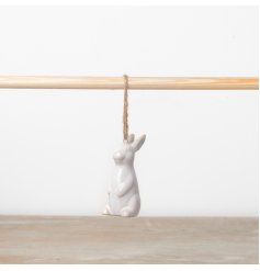 A chic hanging bunny ornament with a cream reactive glaze. Complete with jute string.