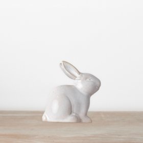 A chic sitting bunny ornament with a natural reactive glaze. Complete with a rustic jute string hanger.