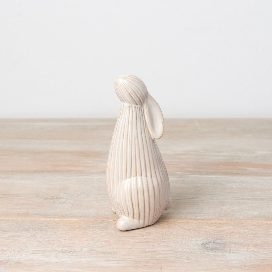 This rustic bunny ornament with a two-tone natural glaze and ribbed surface is a must have seasonal gift.