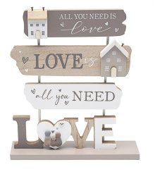 A standing shabby chic wooden plaque adorned with a loving quote. 