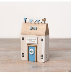 This wooden 'Barefoot Cottage' is sure to add an element of coastal charm to any home space. 