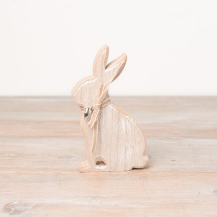 A washed wooden bunny decoration with a fabric bow and dainty silver heart charm. 