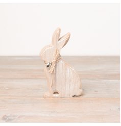 A washed wooden bunny decoration with a fabric bow and dainty silver heart charm. 