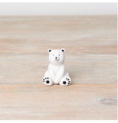 An adorable porcelain bear figure with a delicate speckled finish. A unique sentimental gift item. 