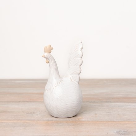 A rustic hen ornament with carved details and a raw and glazed natural finish. 