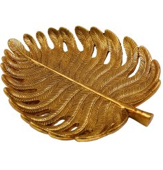 A large trinket plate in the shape of a leaf with a golden colour finish. 