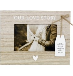 And they lived happily ever after. A shabby chic wooden frame with 'Our love story' wording, a white tag with scripted