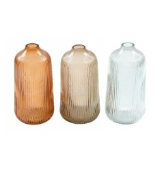 3 assorted glass vases with a ribbed pattern and narrow flute. 