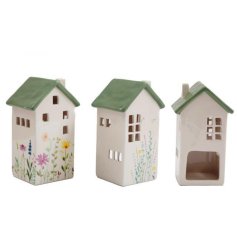 A stylish t-light holder house with a colourful wild flower design painted onto the surface. 