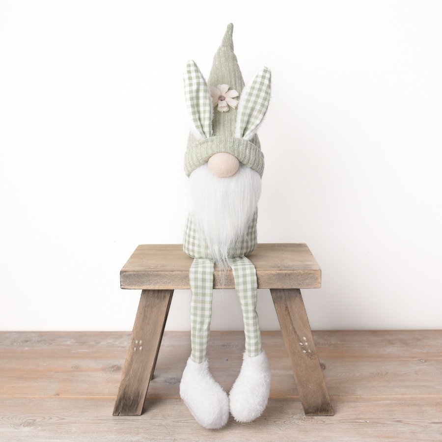 A charming shelf sitting gonk decoration with adorable bunny ears and a white floral detail. 