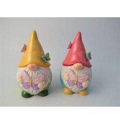 A colourful woodland gnome ornament holding a pink and purple butterfly. 