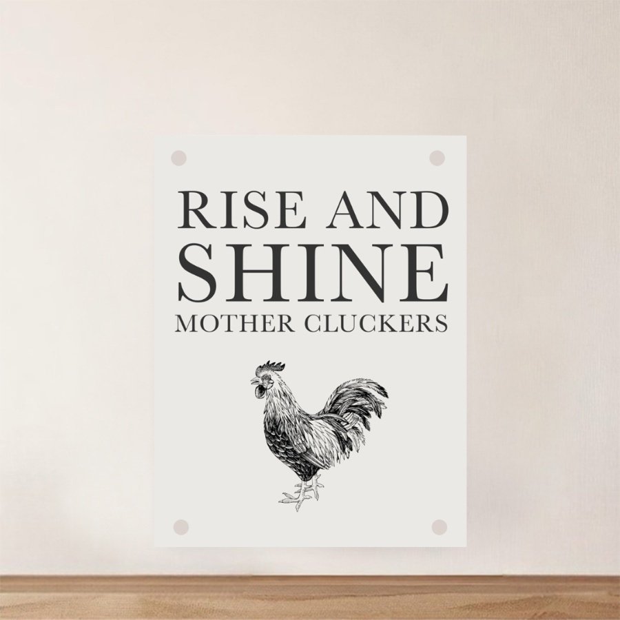A fun quirky farmhouse sign featuring a black printed slogan and rooster. 