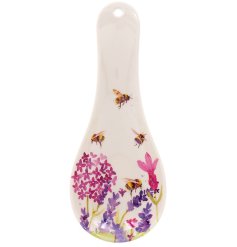 A lavender and bee illustrated spoon rest, complete with a hole for hanging.