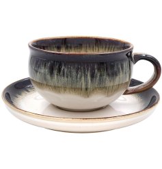 This Reactive Glaze Cup & Saucer Set is the perfect addition to any home