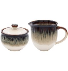 A modern sugar and cream set featuring a trendy reactive glaze finish, making it a fantastic complement to any kitchen.