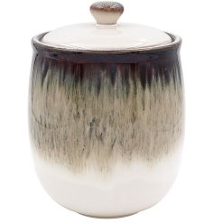 Elevate the style of any space with this 16cm canister adorned with a reactive glaze.