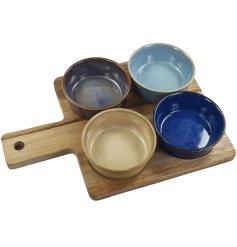 A set of 4 snack dishes presented on a wooden tray.