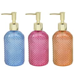 An assortment of 3 stylish soap dispensers with a golden pump lid. 