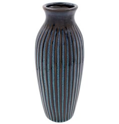 A deep blue ribbed vase finished with a reactive glaze. 
