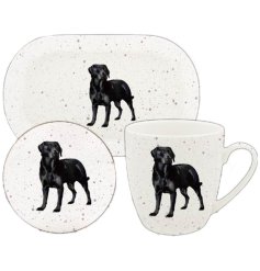 A trio set of a mug, coaster and tray each adorned with a charming black labrador image.