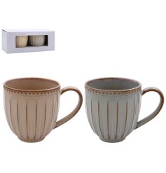 A set of 2 mugs in earthy neutral tones, each finished with a reactive glaze.