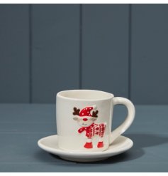 A charming festive reindeer cup and saucer set in white and red.