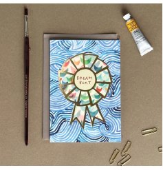 A greetings card for that certain Dreamboat! Featuring a blue swirl pattern with a colourful rosette and golden outline.