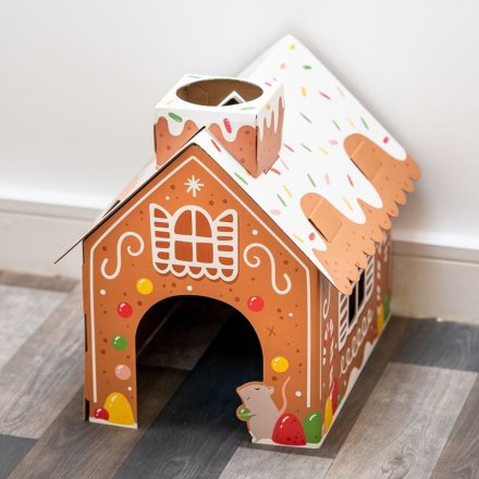 A festive Christmas cat den in a gingerbread house design. 